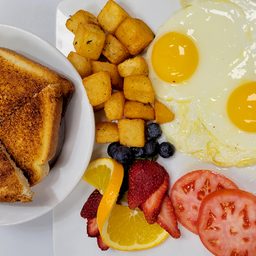 Two eggs with home fries, toast, tomatoes and fruit at Cedar North, London Ontario
