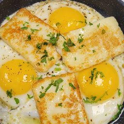 Halloumi eggs in a pan with parsley at Cedar North, London Ontario