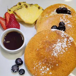Three buttermilk pancakes with fresh fruit and maple syrup at Cedar North, London Ontario