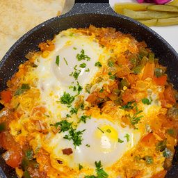 Shakshouka eggs on sauteed vegetables with pita at Cedar North, London Ontario